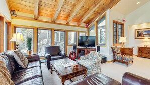 A spacious living room with leather sofas, a wooden coffee table, and a television. - 3 Mi to Vail Village: Classic Estate w/ Hot Tub! (Vail)