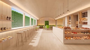 A modern cafe interior with a long counter, bar stools, and a variety of baked goods displayed. - PUBLIC West Hollywood (West Hollywood)