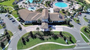 An aerial view of a resort with multiple swimming pools, a central building with a tiled roof, and surrounding landscaped areas. - Game Room, Theater & Pool! Ultimate Disney Oasis (Davenport)