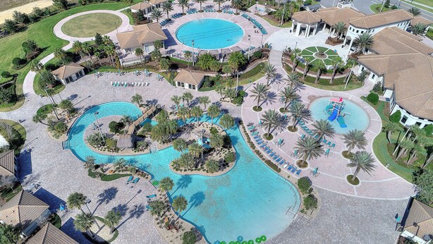 An aerial view of a resort with multiple swimming pools, palm trees, and lounge areas. - Game Room, Theater & Pool! Ultimate Disney Oasis (Davenport)