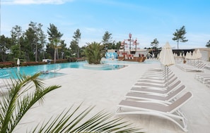 A pool area with lounge chairs, a lifeguard stand, and a ship-themed play structure. - Lovely (sta)caravan in Vabriga (Vabriga)