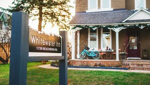 A sign for Whitewater Inn at 1739 Beachburg Rd. - Modern, Spacious 4-Bedroom Home with Garden & Garage (Beachburg)