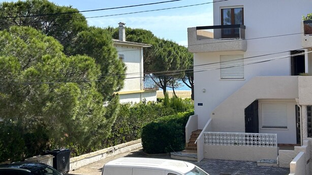 A modern two-story building with a white facade, a balcony on the upper floor, and a staircase leading to the entrance. - Apartment for 4 with parking near beach (Argelès-sur-Mer)