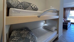 A bunk bed with patterned bedding and a metal ladder. - Cozy Apartment for 4 with Balcony and Parking in Montgenèvre (Montgenèvre)