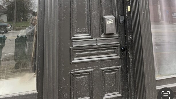 A black door with a mailbox and a window above it. - Boutique Three Bedroom Apartment (La Porte)
