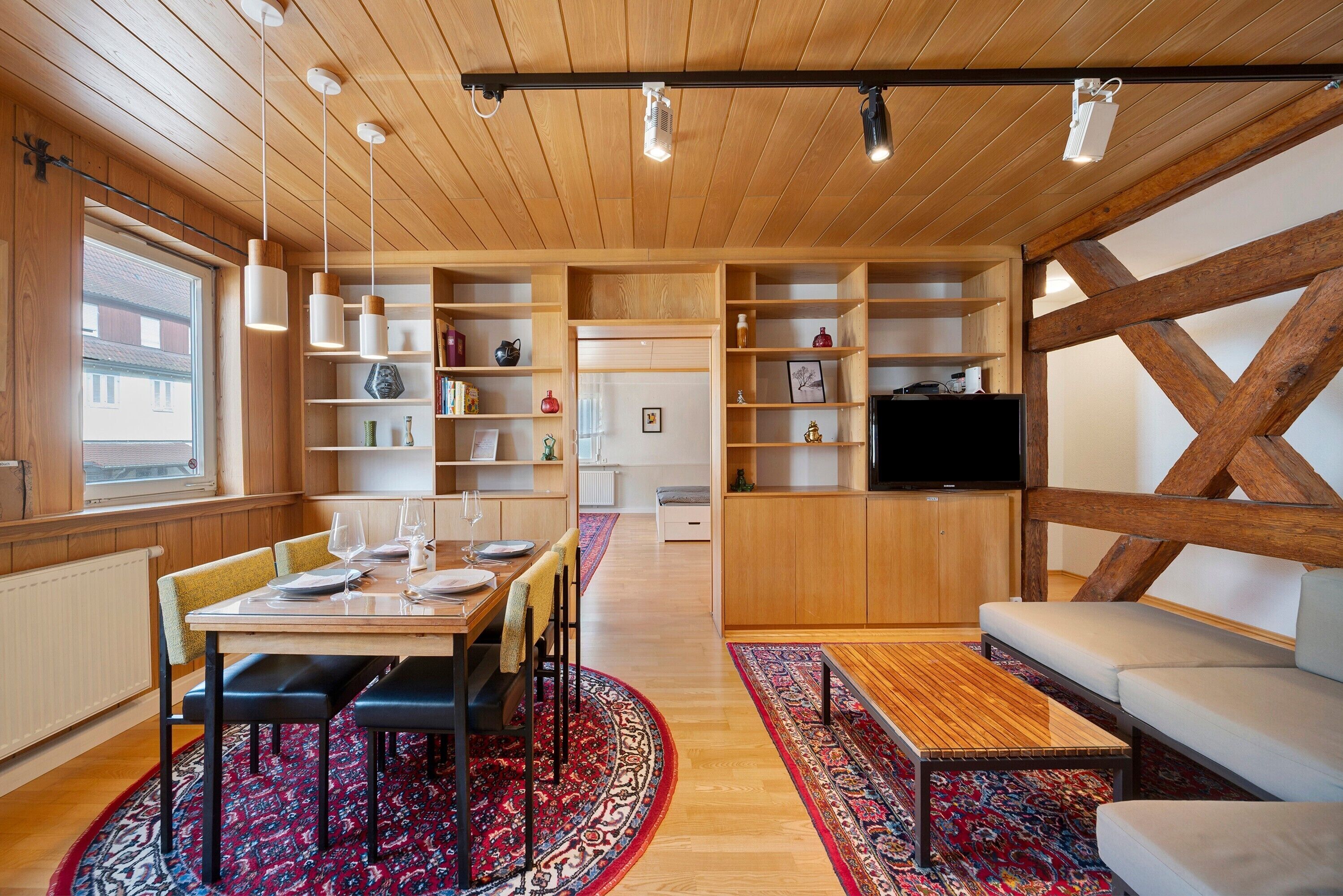 Ein modernes Interieur mit Essbereich, Sofa und eingebauten Regalen.