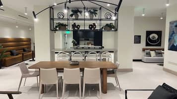 A modern interior with a dining area, kitchen, and seating space.