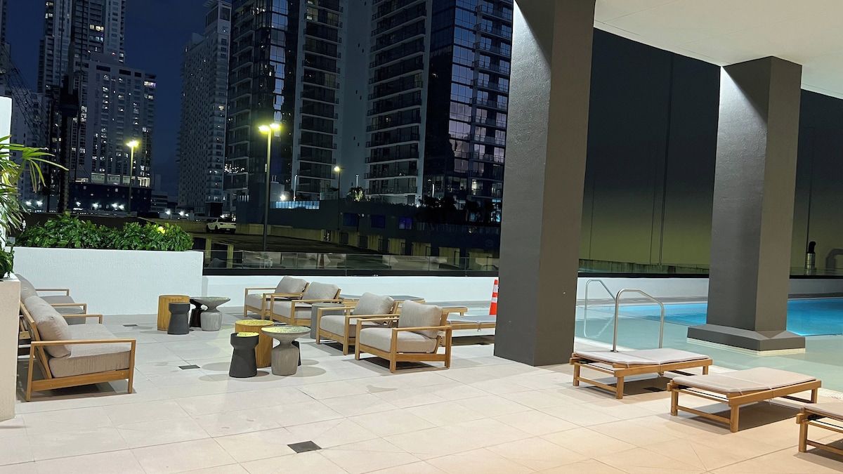 A rooftop lounge with outdoor seating and a pool.