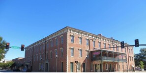 A historic brick building with a flat facade, large windows, and a covered front porch. - Modern 2BR Midtown Comfort Stay in Columbus (Columbus)