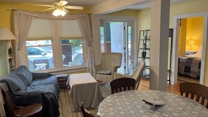 A cozy living room with a sofa, chairs, a small table, and a ceiling fan. - 317 Maple Unit 2 in Lakeside (Lakeside)