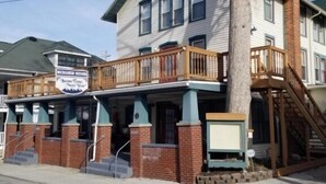 A two-story building with a balcony and a staircase leading to the second floor. - 317 Maple Unit 2 in Lakeside (Lakeside)