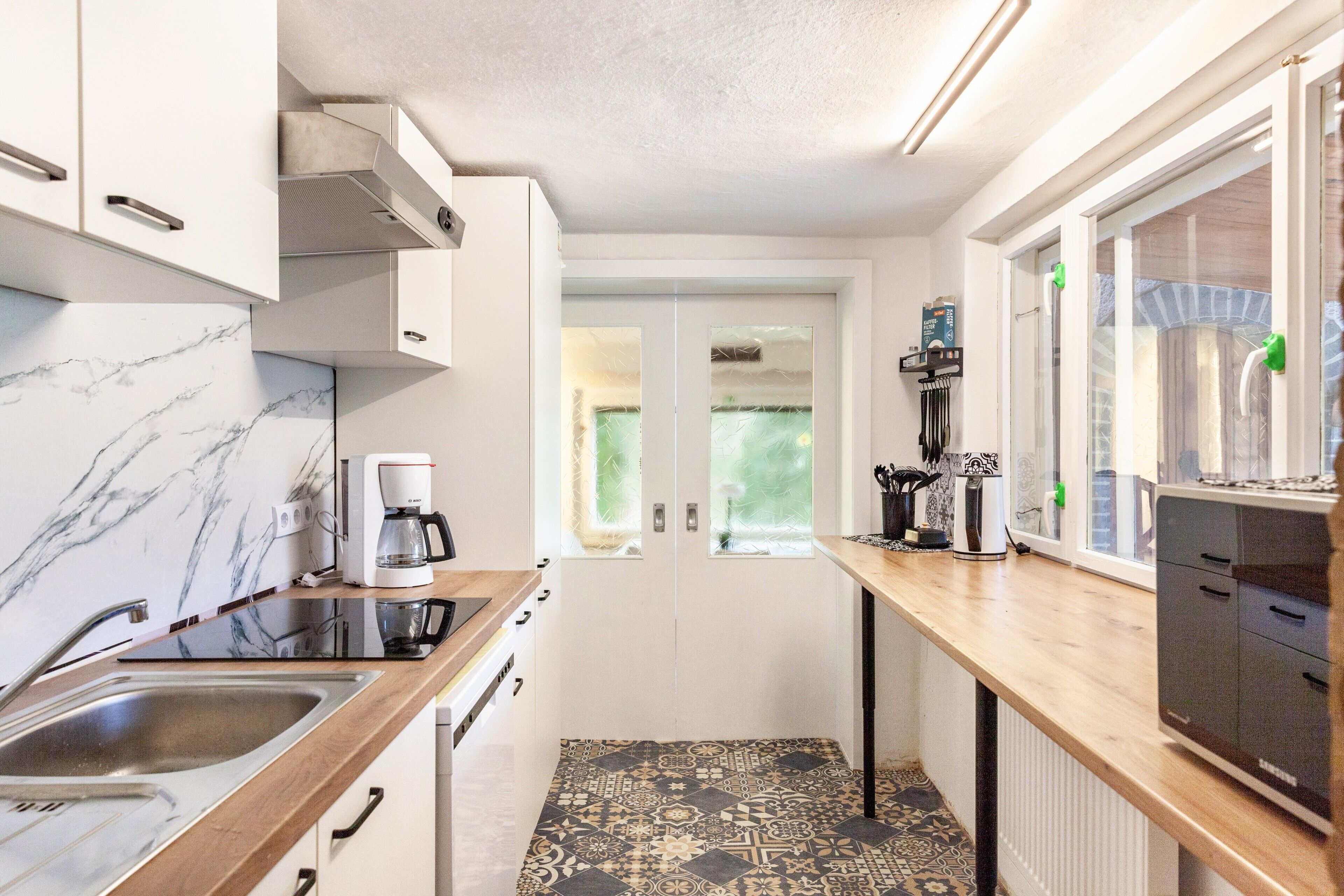 Fridge, stovetop, dishwasher, coffee/tea maker