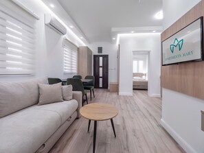 Suite Deluxe, patio | Área de sala de estar | Televisión LCD de 32 pulgadas con canales por cable 