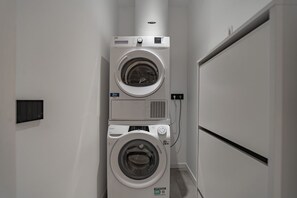 A laundry room with two stacked front-loading washing machines. - 9 min. Walk from Porta Nuova, Design and Elegance (Milan)