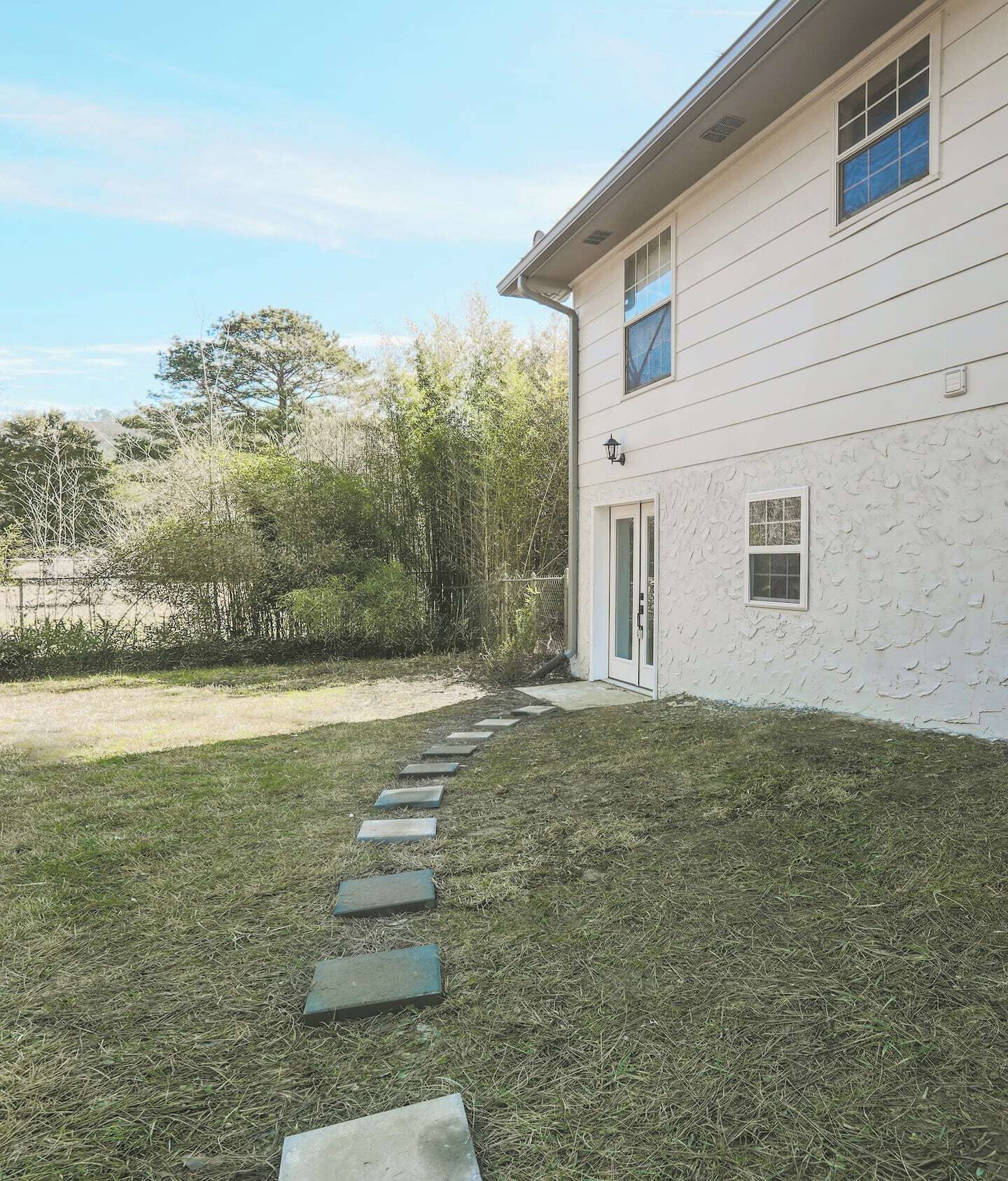 A house with a pathway leading to the front door.