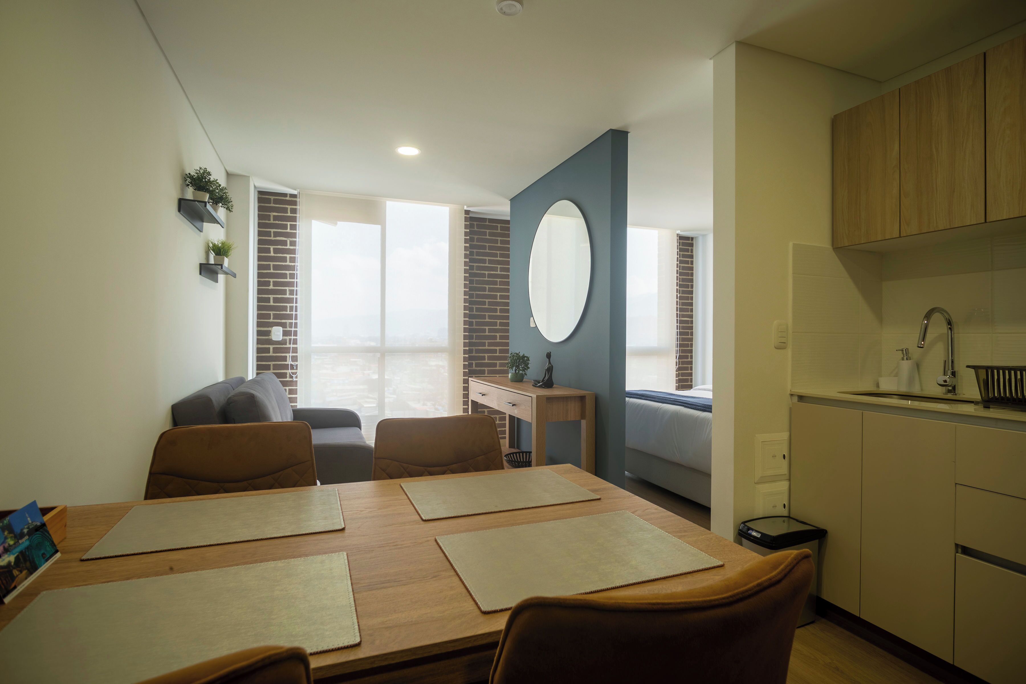 A modern kitchen with wooden cabinets, a sink, and a countertop.