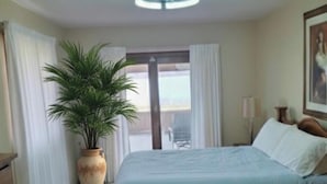 A bedroom with a bed, a potted plant, a nightstand, and a window with curtains. - 10 passengers pontoon boat  with Golfcart INCLUDED great fishing and swimming  (Trufant)