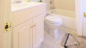 A bathroom with a toilet, sink, and bathtub. - Studio Not Far from Capitol Hill, Walk to METRO (Washington)