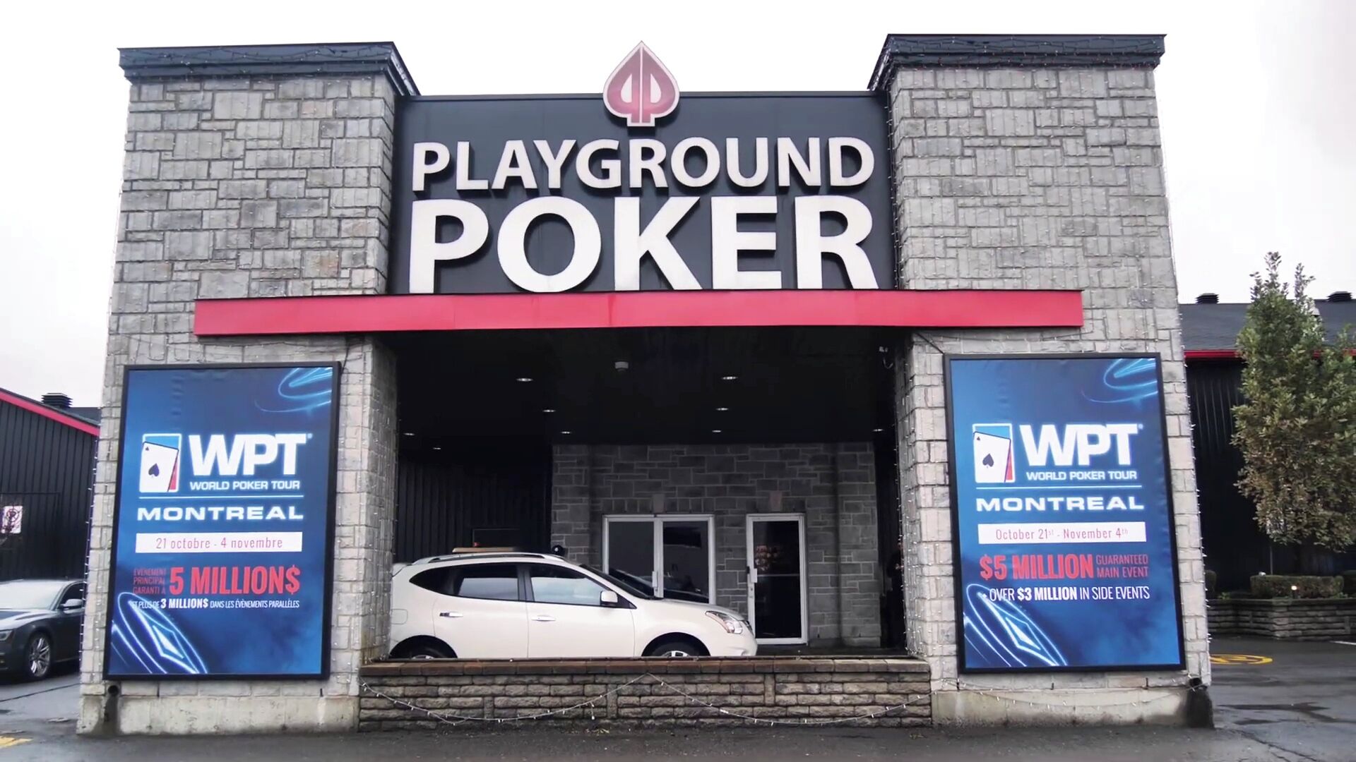 A building with a sign that reads "PLAYGROUND POKER." There are two large posters on either side of the entrance advertising the World Poker Tour in Montreal with dates and prize money.