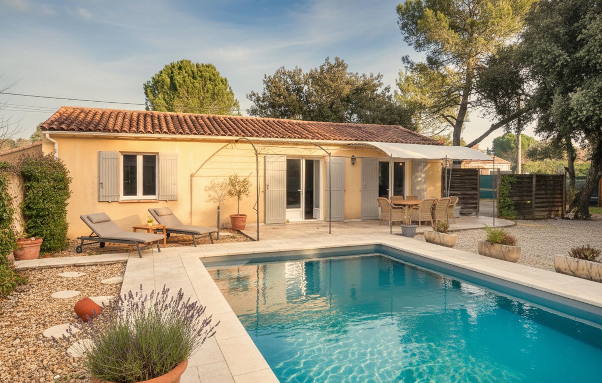 A house with a swimming pool, outdoor furniture, and a covered patio area.