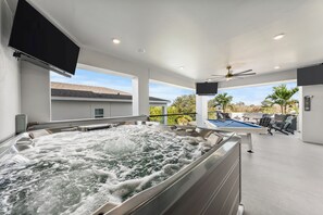 A modern indoor pool area with a hot tub, ceiling fans, and a pool table. - Amazing Kids Themed Bedrooms | Games Room |Theater Room | Golf Simulator Room | Golf Course Views (Kissimmee)