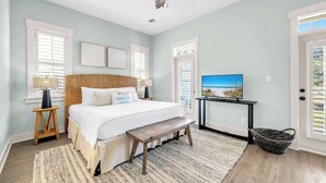 A bedroom with a bed, a ceiling fan, a TV, and a window with blinds. - Resting Beach Place by Stay on 30a (Seacrest Beach)