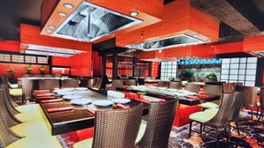 A restaurant with high ceilings, red walls, and a variety of seating arrangements including tables and chairs. - Luxury Experience-4BR Villa-10 people-Las Vegas Resort & Casino-Ideal for Groups (Las Vegas)