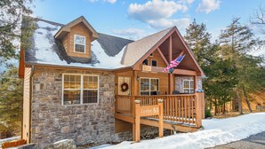 A lodge with a stone facade, a wooden deck, and a sign reading "Lodge 51".