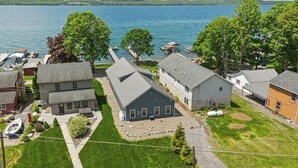 A residential area with houses, a dock, and a lake. - Mott's Lakefront Landing: Dog-Friendly Lakefront Escape on Seneca Lake! (Lodi)
