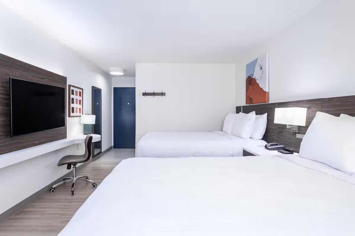 Settle into crisp bedding with a sleek work desk.