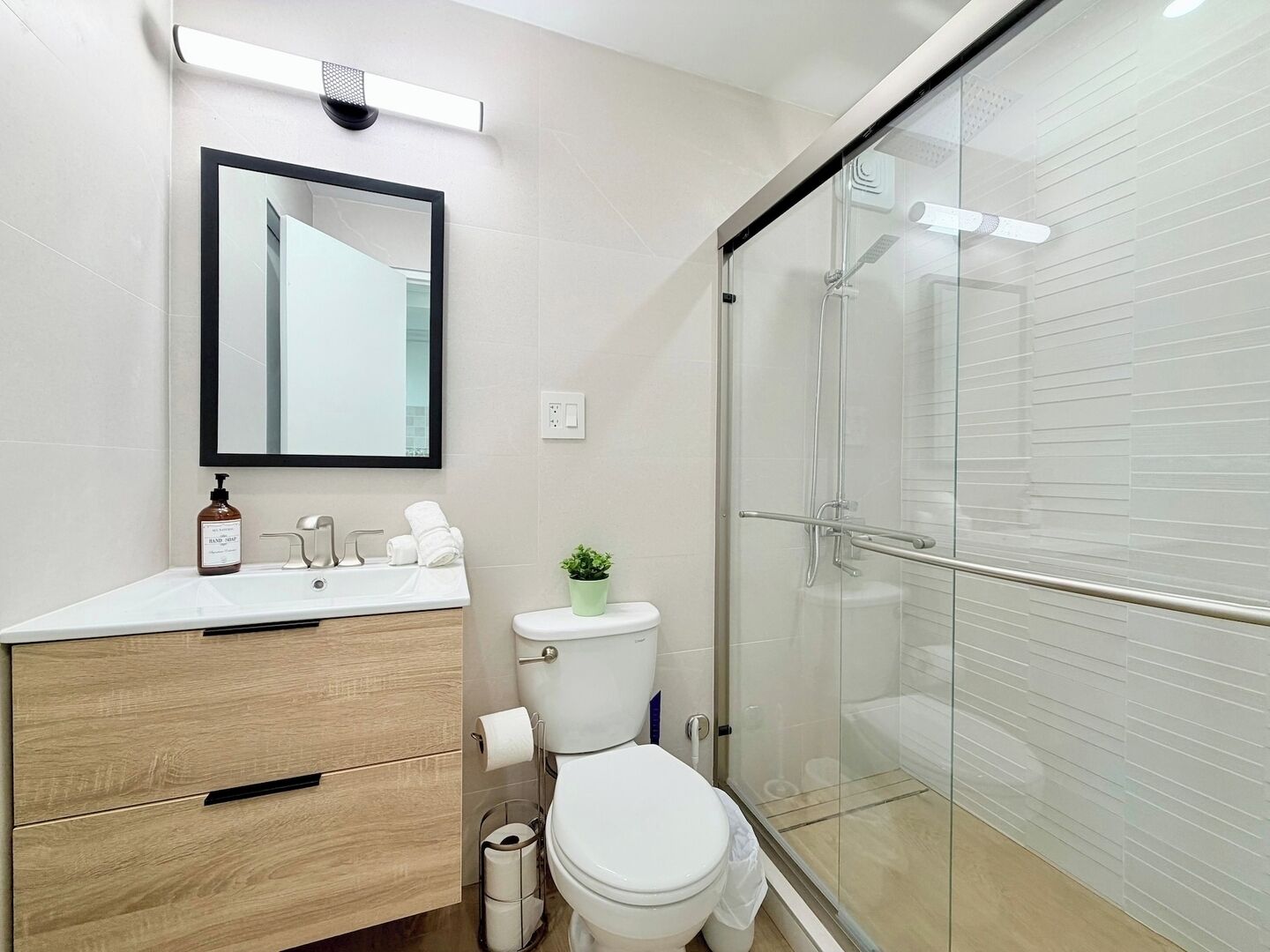 Ein modernes Badezimmer mit Toilette, Waschbecken und Dusche.