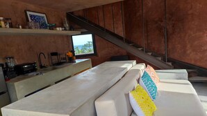 A modern kitchen with a built-in stove, a coffee machine, and a window overlooking the outdoors. - Ideal cottage to rest with the family very close to the sea, one pet is accepted. (El Sargento)
