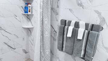 Shower, hair dryer, towels, soap