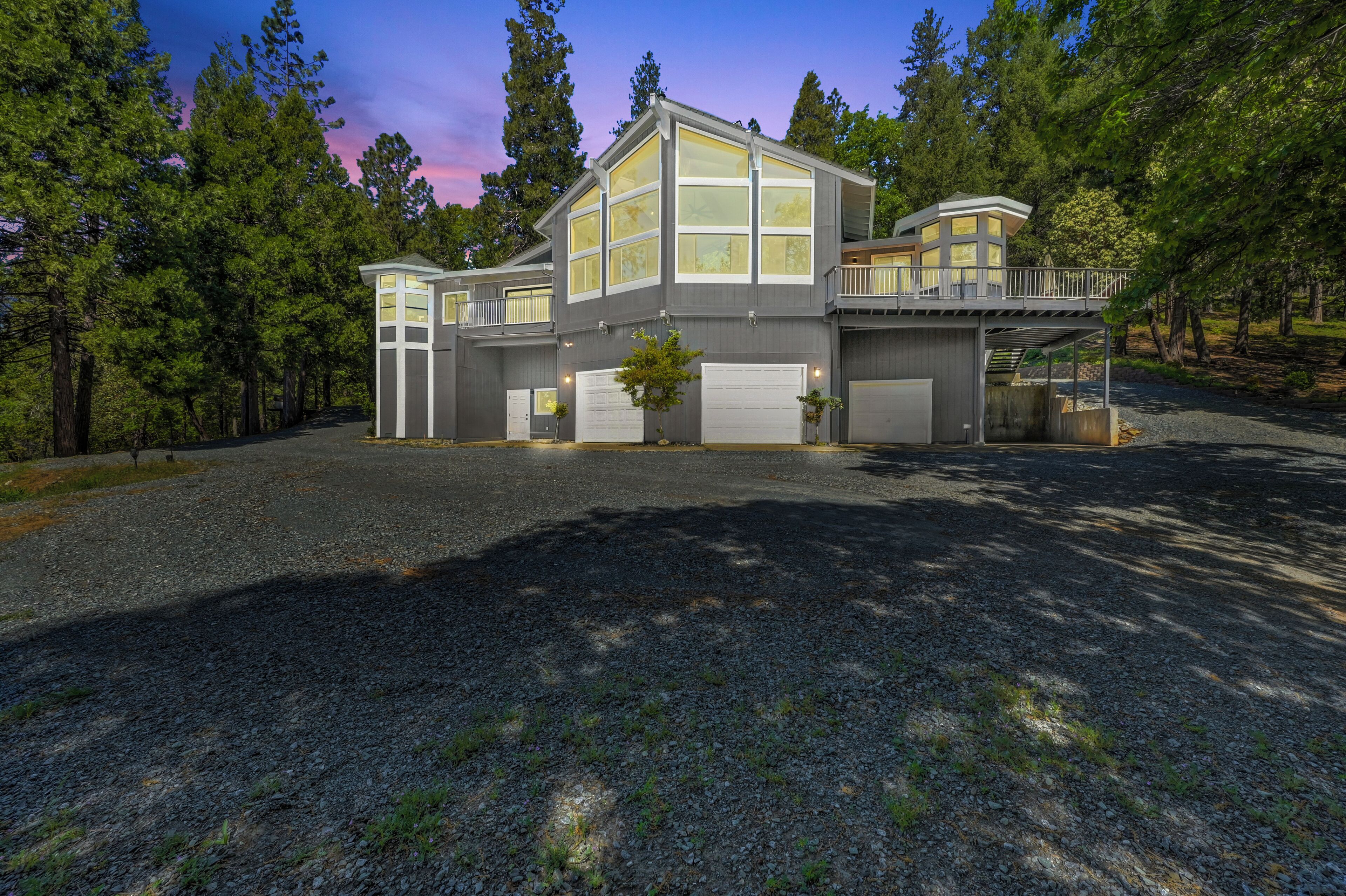 A modern two-story house with a large garage, a covered porch, and a driveway.