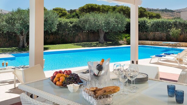 A poolside dining area with a table set for two, featuring fruits, bread, and wine glasses. - Beautiful private villa for 6 people with A/C, WIFI, private pool, TV, veranda and panoramic view (Cornino)
