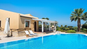 A pool area with lounge chairs and a covered patio. - Beautiful private villa for 6 people with A/C, WIFI, private pool, TV, veranda and panoramic view (Cornino)