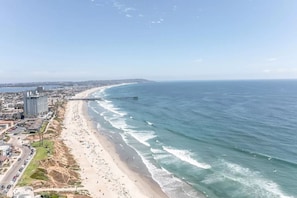 A coastal cityscape with a beach, a pier extending into the ocean, and buildings along the shore. - 3 Ocean Front Units * 3 Patios * 2 Levels (San Diego)