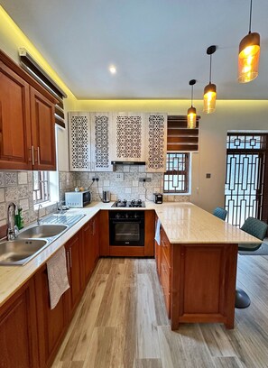 Microwave, oven, stovetop - Serene 3-Bedroom Serviced Apartment in Kampala (Kampala)