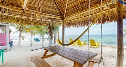 Rustic overwater cabin with oceanfront deck, island kitchen & sea breeze views