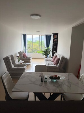 A modern living room with a marble table, two sofas, and a bookshelf. - Private 2BR Apartment · Quiet · Prime Location (Medellín)