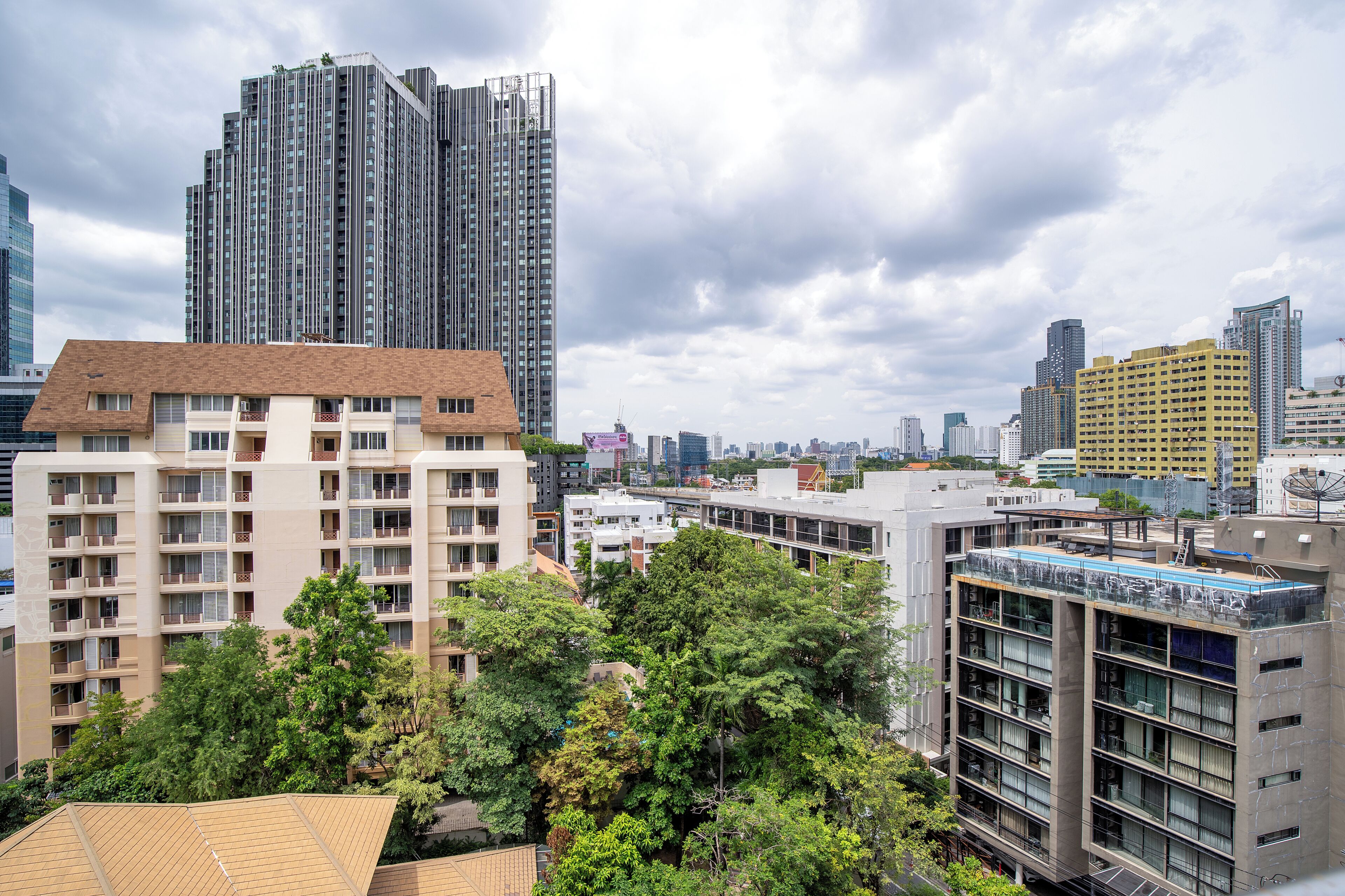 A high-rise building with multiple balconies and a modern architectural design.