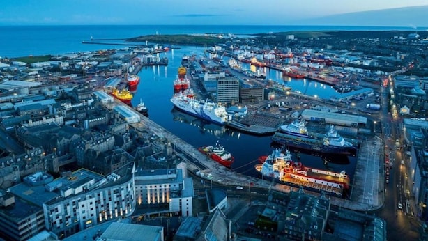 An aerial view of a port city with multiple docks, ships, and industrial buildings. - Aberdeen City Escape Apartment (Aberdeen)