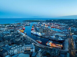 An aerial view of a port city with multiple docks, ships, and industrial buildings. - Aberdeen City Escape Apartment (Aberdeen)
