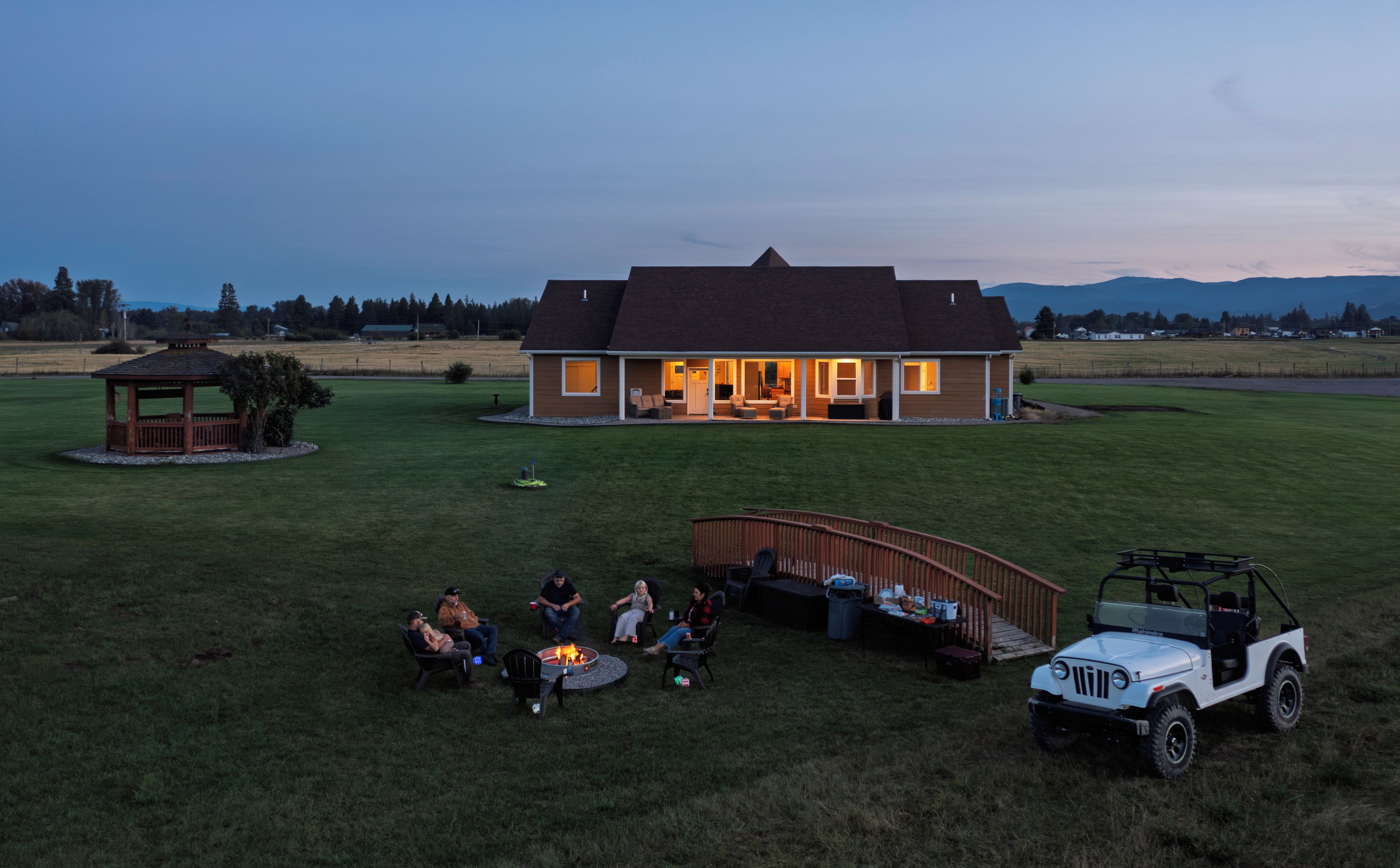 A house with a covered patio area and a small gazebo.
