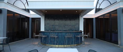 An outdoor bar area with a counter and seating.