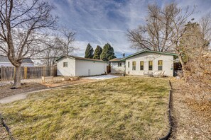 A two-story house with a covered patio and a fenced yard. - 4 Mi to Riverwalk & CSU Pueblo! Home w/ Sunroom (Pueblo)