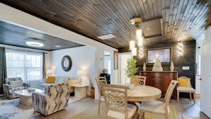 A modern living room with a wooden ceiling, a dining area with a round table and chairs, and a cozy seating area with sofas and a coffee table. - Explore Historic Dtwn Punta Gorda! Home w/ Deck (Punta Gorda)