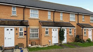 A row of terraced houses with white doors and windows, brick walls, and a tiled roof. - 2 bedroom accommodation in Westwood, near Margate (Westwood, near Margate)
