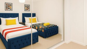 A bedroom with two beds, a large mirror, and artwork on the wall. - 3 bedroom accommodation in Sittingbourne (Sittingbourne)