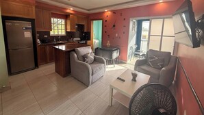 A compact living space with a kitchen, dining area, and seating. - TORRE ALTA 1 Bedroom Apt 5B (Puerto Plata)